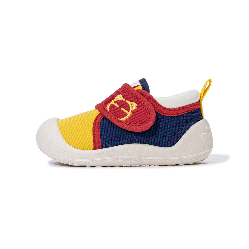 Side view of yellow EBMINI PICO color-block toddler shoe
