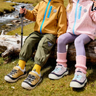 Children wearing yellow and purple EBMINI RIDGE hiking sneakers outdoors