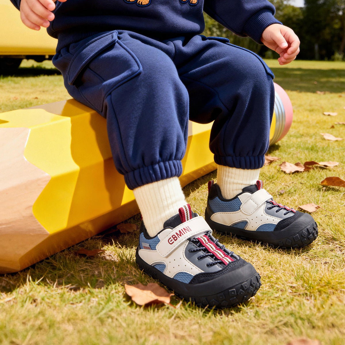 Child wearing EBMINI ROVER black outdoor toddler sneakers at the park