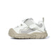 Side view of white EBMINI SHIELD wide-toe sneaker with protective bumper