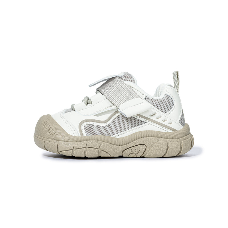 Side view of white EBMINI SHIELD wide-toe sneaker with protective bumper